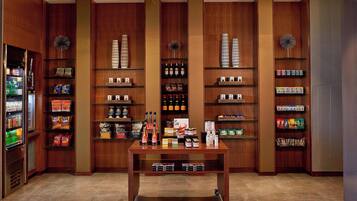 A well-organized retail space with shelves stocked with snacks, beverages, and other items.