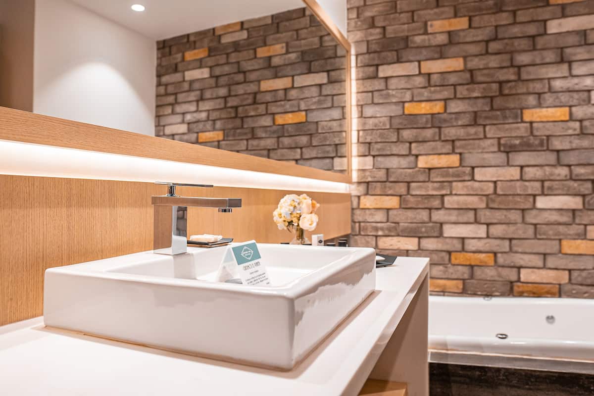 suite, 1 king bed, hot tub | bathroom | free toiletries, hair dryer, towels, soap