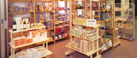 Una tienda con varias estanterías de madera llenas de diversos artículos, incluyendo productos en caja, bolsas y otra mercancía.
