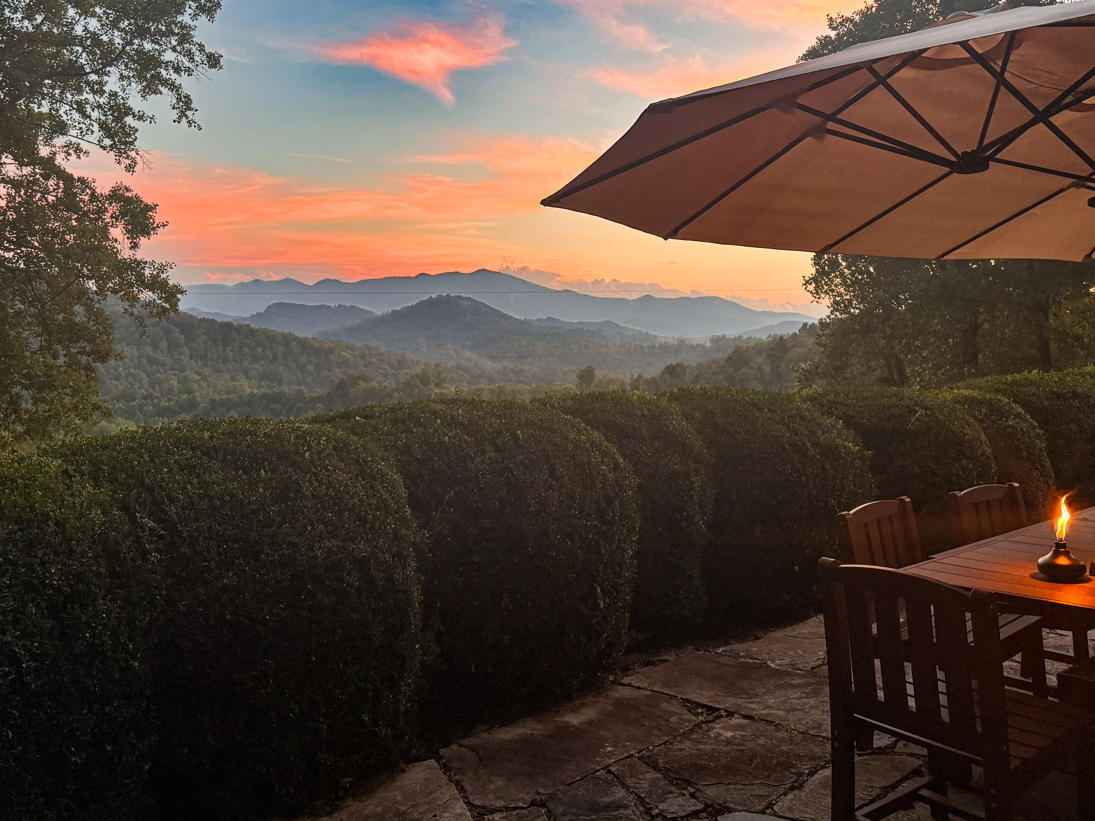 Sunset mountain-view patio with private outdoor dining and cozy ambiance