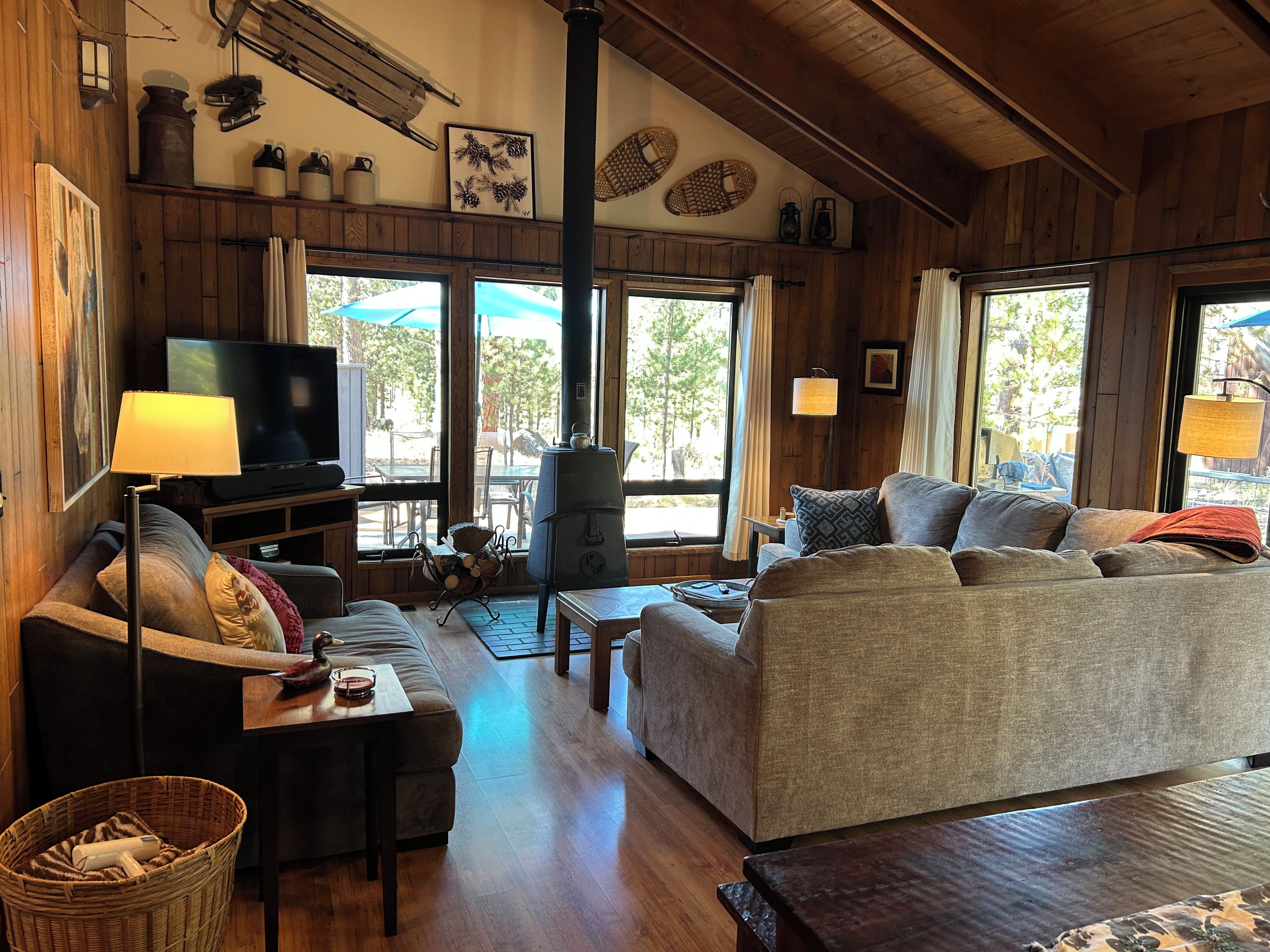A cozy living room with a sofa, a television, and a fireplace.