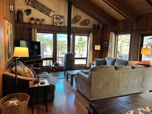 A cozy living room with a sofa, a television, and a fireplace.