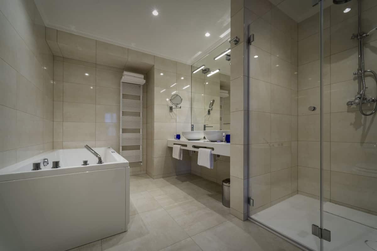 luxury suite, 1 queen bed and 1 sofa, city view | bathroom | free toiletries, hair dryer, bathrobes, slippers