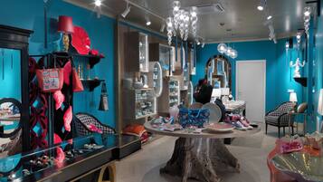 A modern interior with a central wooden table, surrounded by various decorative items and furniture.