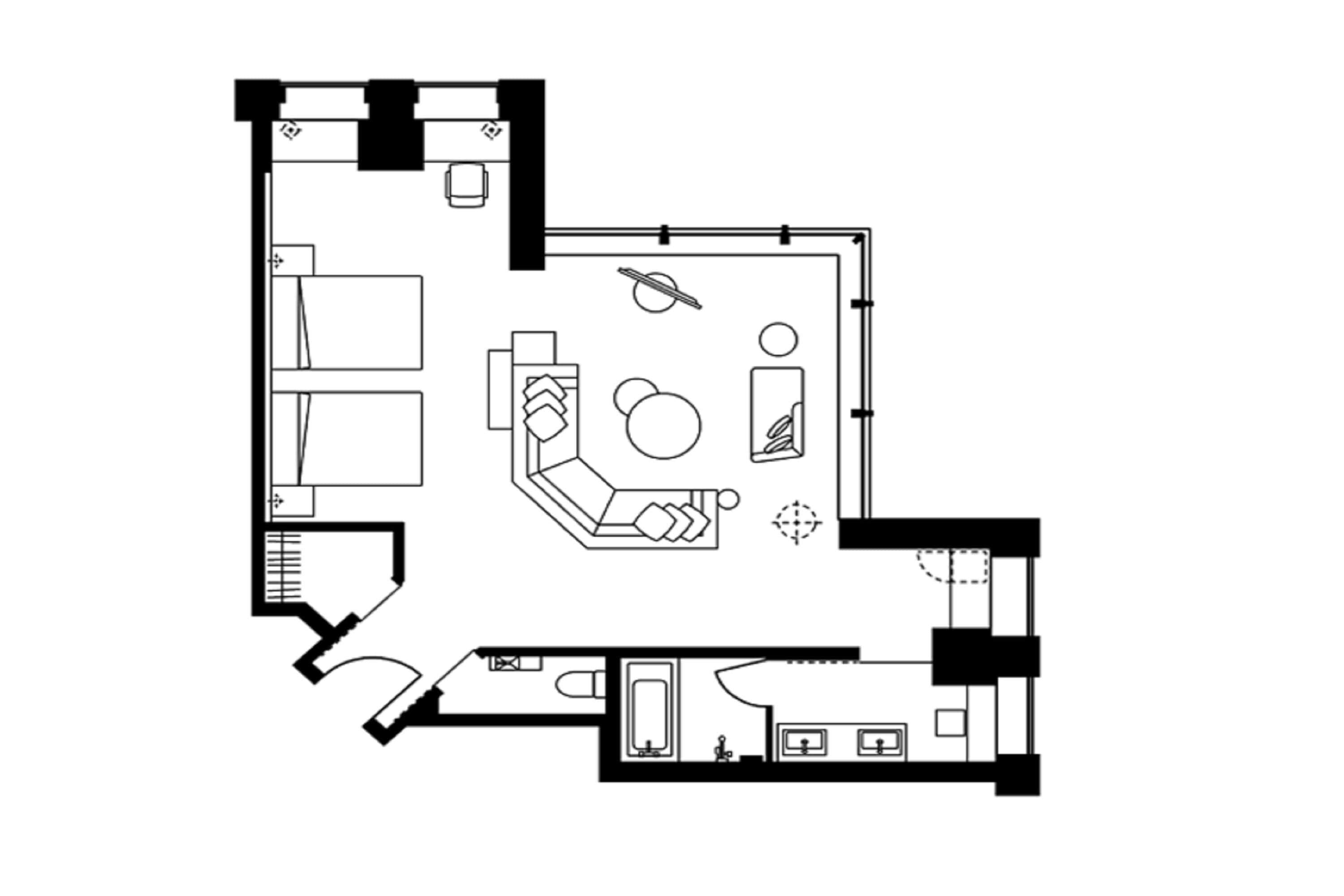 A hotel layout with a central living area, a separate bedroom, a bathroom, and a kitchenette.