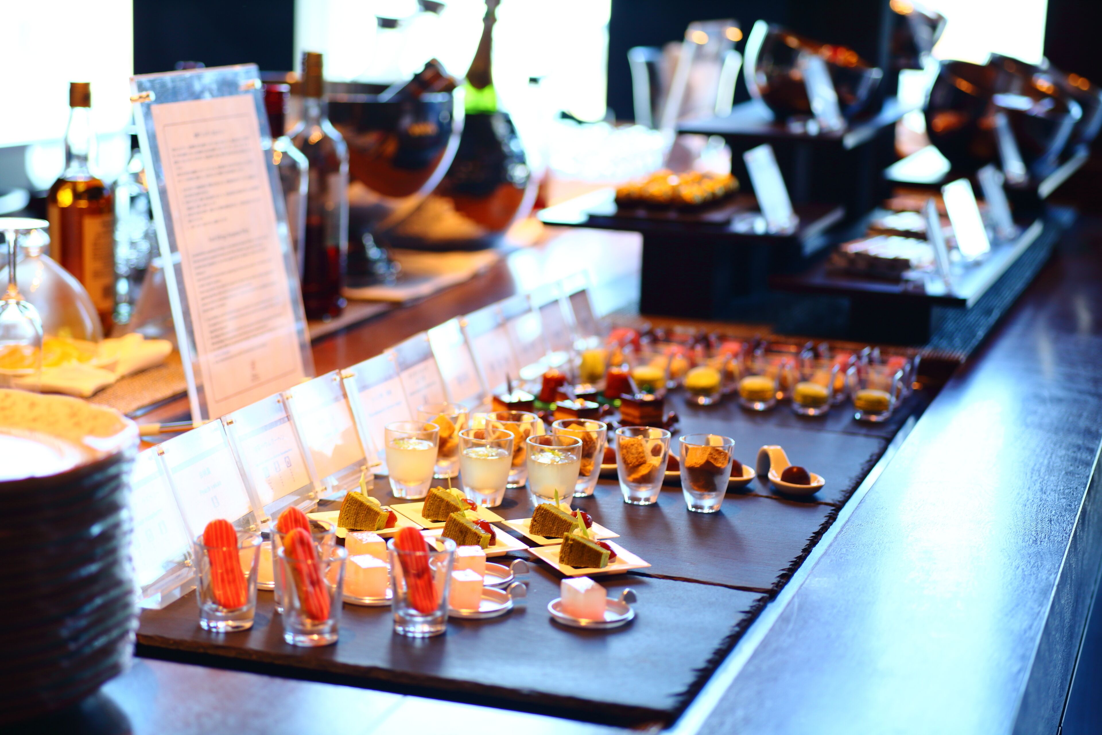 A buffet bar with various food items and drinks.