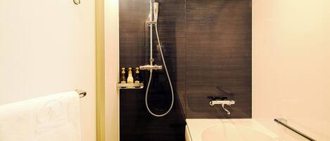 A modern bathroom with a shower, a bathtub, and a toilet.