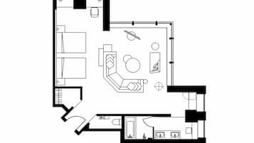A hotel room layout with a bed, seating area, and bathroom.