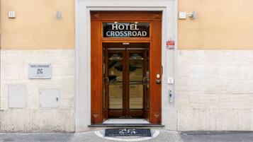 A hotel entrance with a wooden door and a sign that reads "HOTEL CROSSROAD."