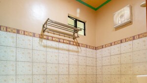 Een badkamer met toilet, douche en wastafel.