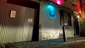 A brick building with a sign reading "Greyjars" illuminated by neon lights. - Greyfriars Lodge (Canterbury)