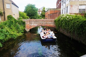 A narrow canal with a boat carrying passengers. - Greyfriars Lodge (Canterbury)