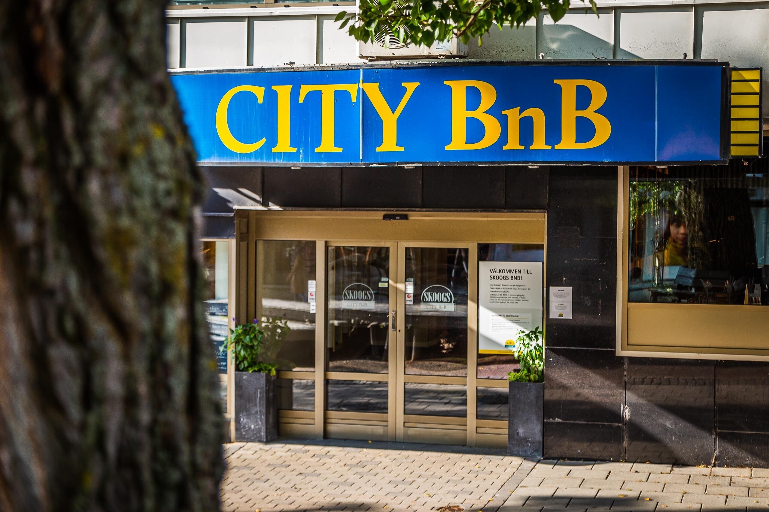 A storefront with a blue sign reading "CITY BnB".