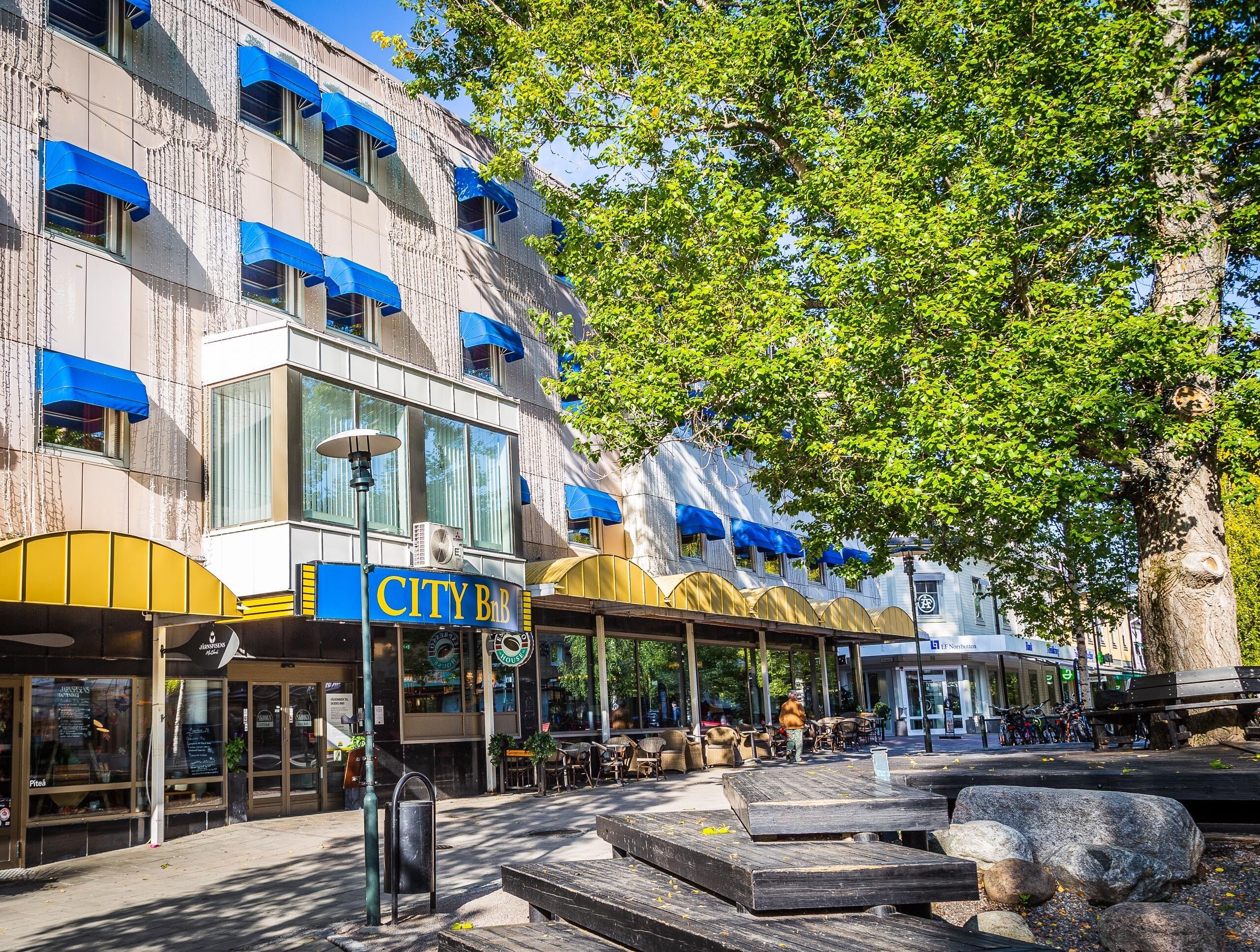 A City Bar with outdoor seating and a covered patio area.