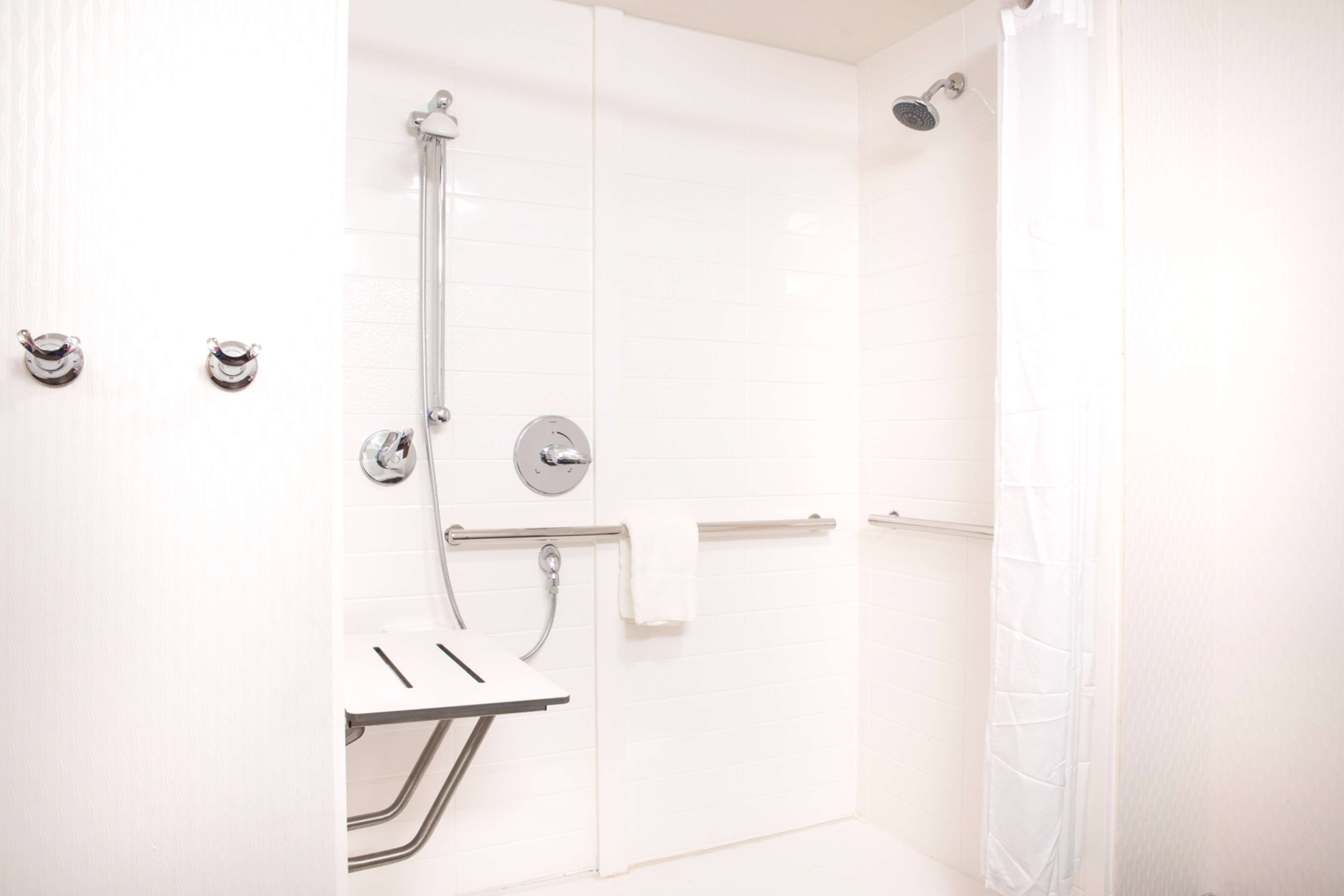 Un baño moderno con cabina de ducha, inodoro y lavamanos.