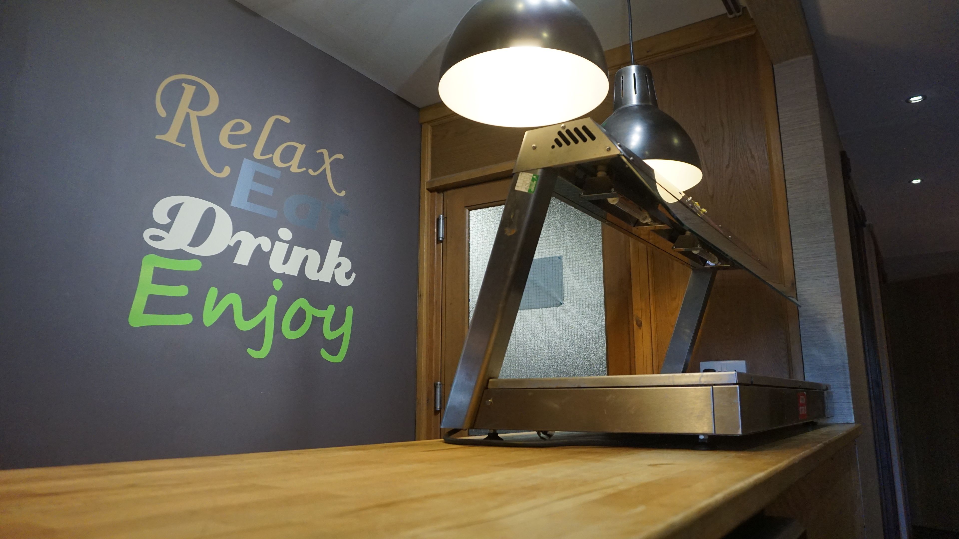 A wall with motivational text and a desk lamp.
