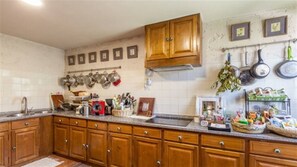Fully equipped kitchen with pots, pans, and ample storage.