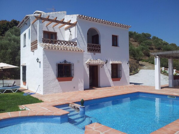 A two-story white building with a swimming pool, a pergola, and a view of the surrounding landscape. - Rural house 15 minutes away from the beach. Private swimming pool and free WIFI (Torrox)