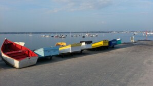 A row of colorful boats parked on a concrete dock by a calm body of water. - Fouesnant, Beg-Meil, very nice apartment sleeps 6, beaches and market town (Fouesnant)
