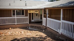 A lodge with a wooden exterior, a porch, and a sign reading "The Family Lodge."