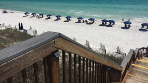 A wooden boardwalk leading to a sandy beach with blue umbrellas and lounge chairs. - Adagio D405 Private Top 4th Floor Corner!! Premium Pool Front!+ Ice Maker! (Santa Rosa Beach)
