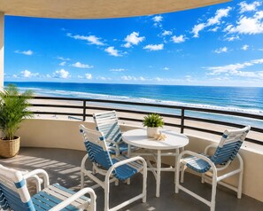 A balcony with a view of the ocean, white chairs, a small table with a plant, and a potted plant.