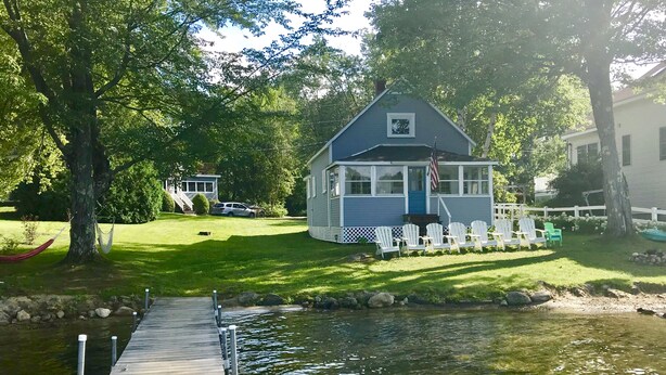 A lakeside cabin with a dock extending into the water. - Charming lake front cabin on Highland Lake (Andover)
