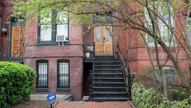 A red brick building with a black staircase leading to the entrance, a wooden door, and a sign indicating ADA accessibility. - Cap Hill 1-level Loft-style 2 Bedroom, near Capitol, Eastern MarketFREE Parking, (Washington)
