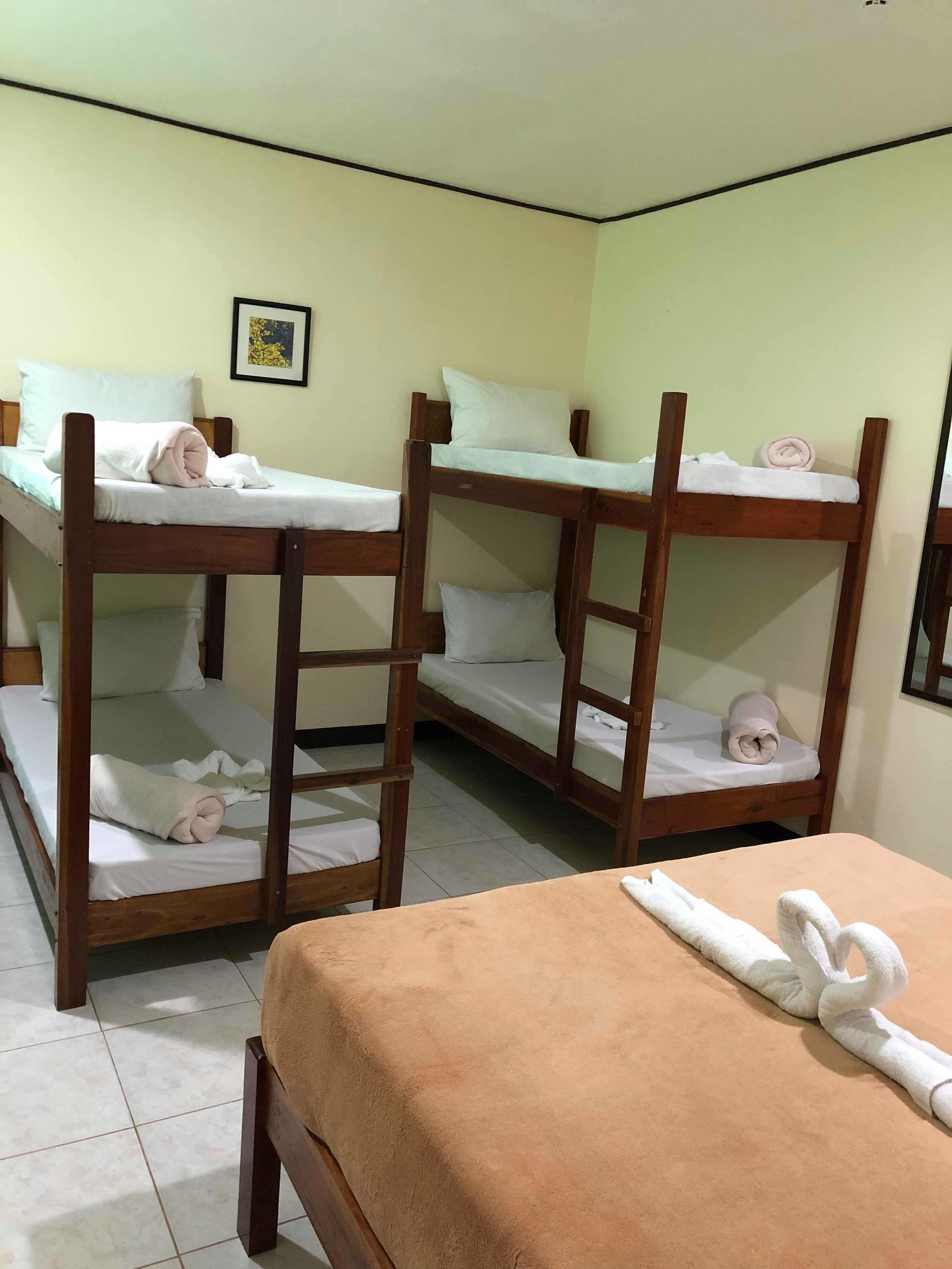 A room with bunk beds and a single bed.