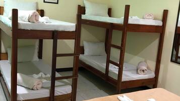 A room with bunk beds and a single bed.