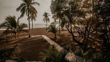 On the beach, black sand, sun-loungers, beach towels