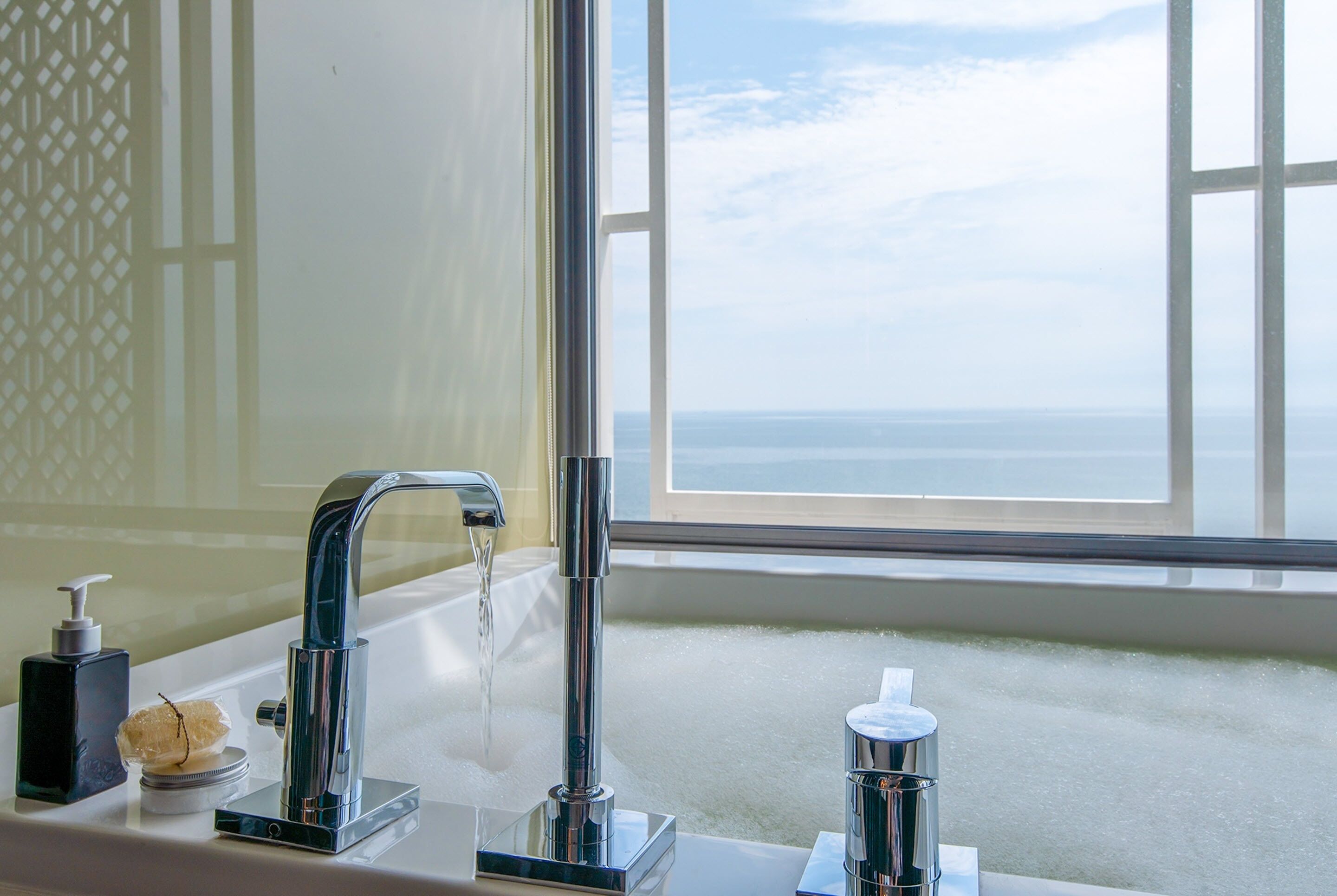 baba grand ocean suite corner | bathroom | separate bathtub and shower, rainfall showerhead, designer toiletries