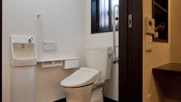 Un baño pequeño y moderno con inodoro, lavabo y ventana.