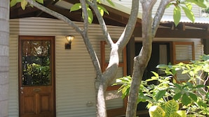 A house with a wooden door and a welcome mat. - Beach House on Fox (Cable Beach)