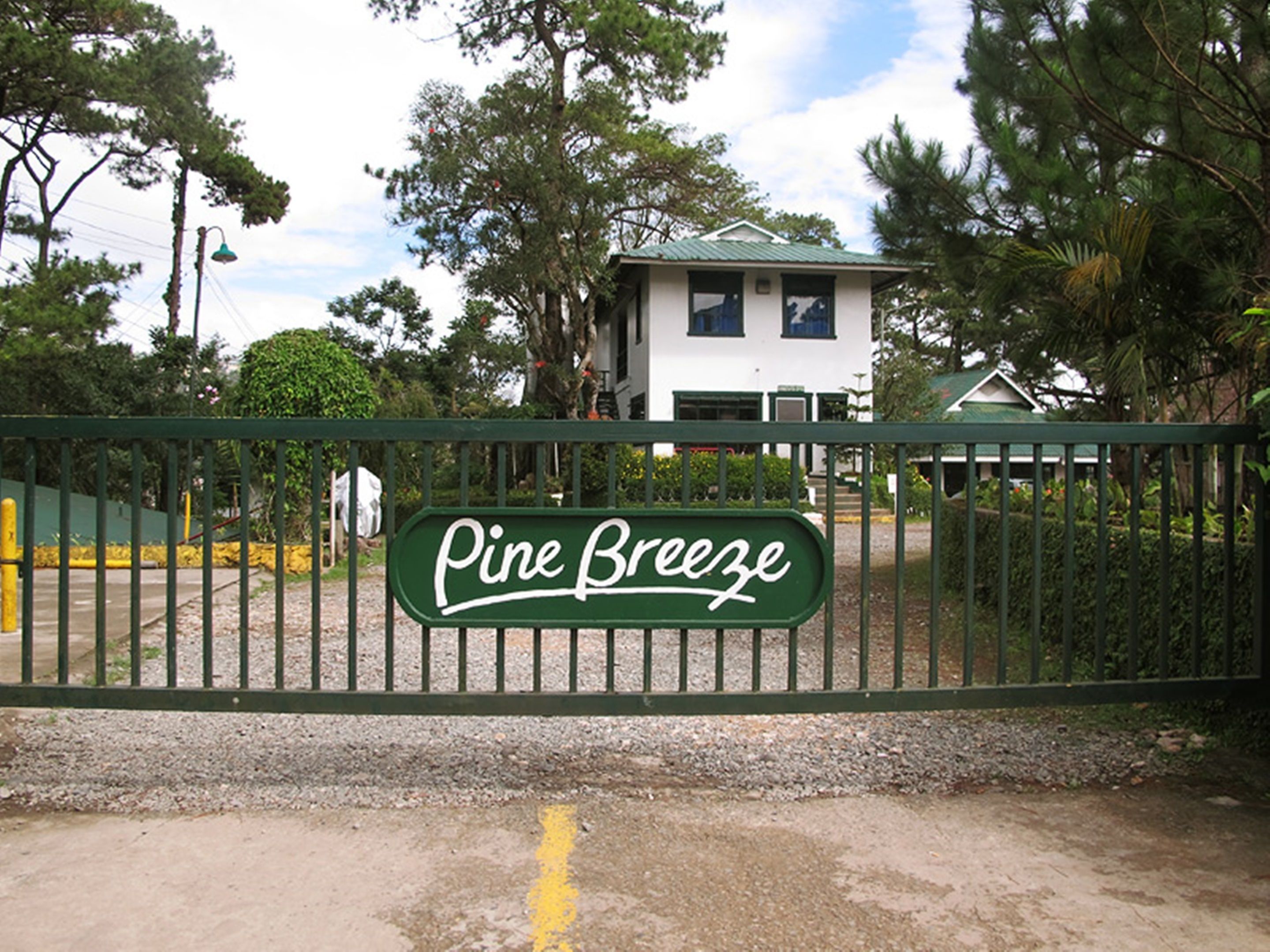 A gated entrance with a sign reading "Pine Breeze."
