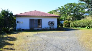 A small building with a red roof and a signboard. - Yakushima Guesthouse Suginoko (Yakushima)