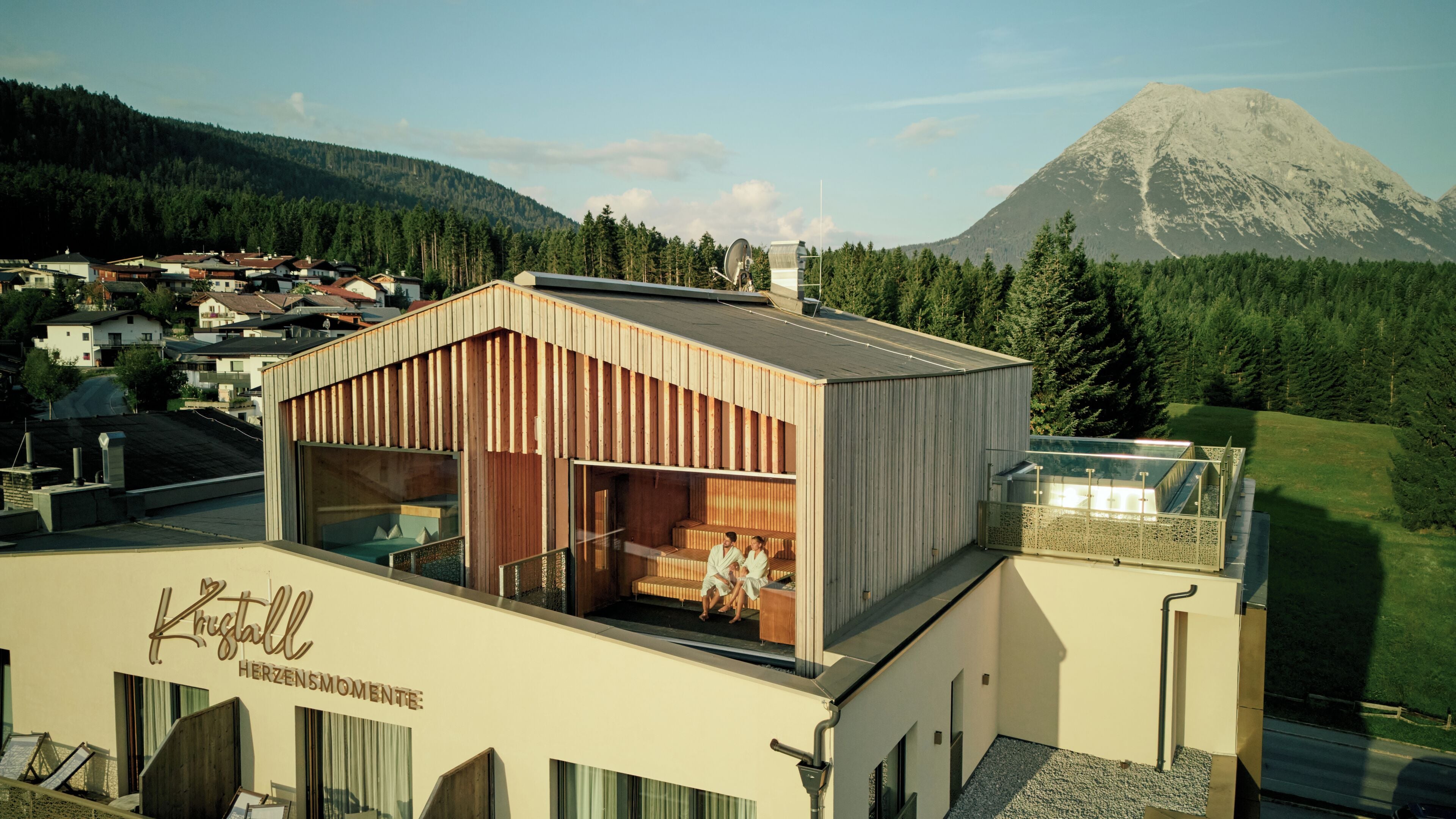 A modern building with a wooden exterior and a glass balcony.