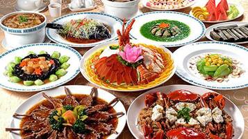 A variety of dishes on a table, including seafood and vegetables.