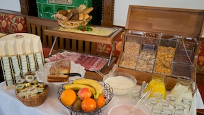 A breakfast buffet with various food items and beverages.