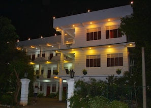 A multi-story building with a symmetrical facade, multiple windows, and a central staircase. - Hotel senora kataragama (Kataragama)
