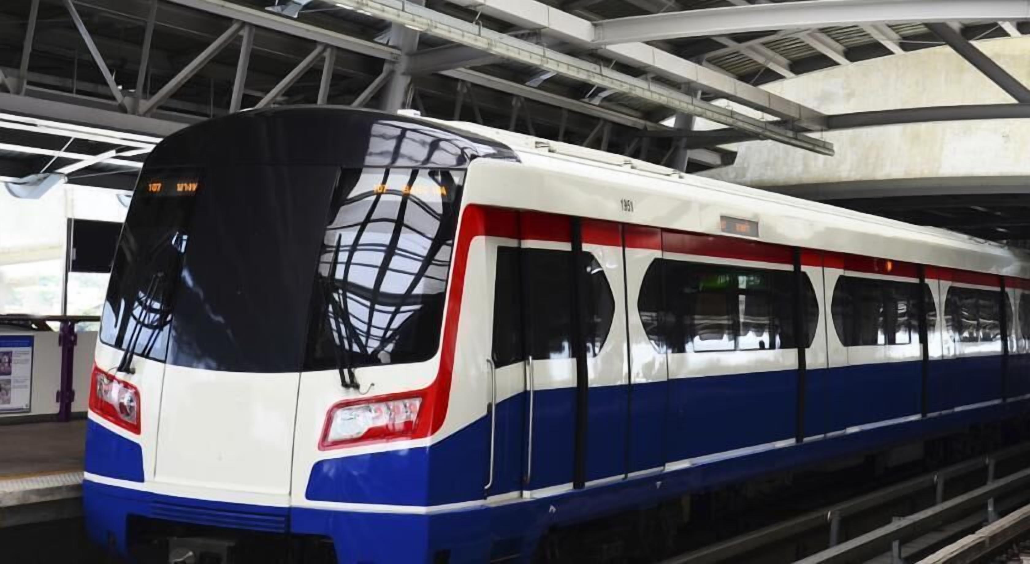 A modern train with a sleek design, featuring a prominent front windshield and a color scheme of white, blue, and red.