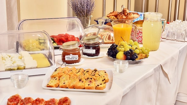 A breakfast buffet with various food items, including fruits, pastries, and spreads. - President Hotel (Timisoara)