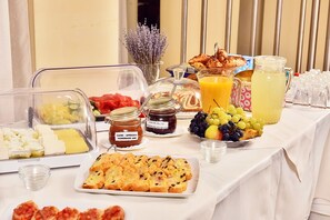 A breakfast buffet with various food items, including fruits, pastries, and spreads. - President Hotel (Timisoara)