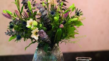 A vase with a floral arrangement on a copper-colored counter.