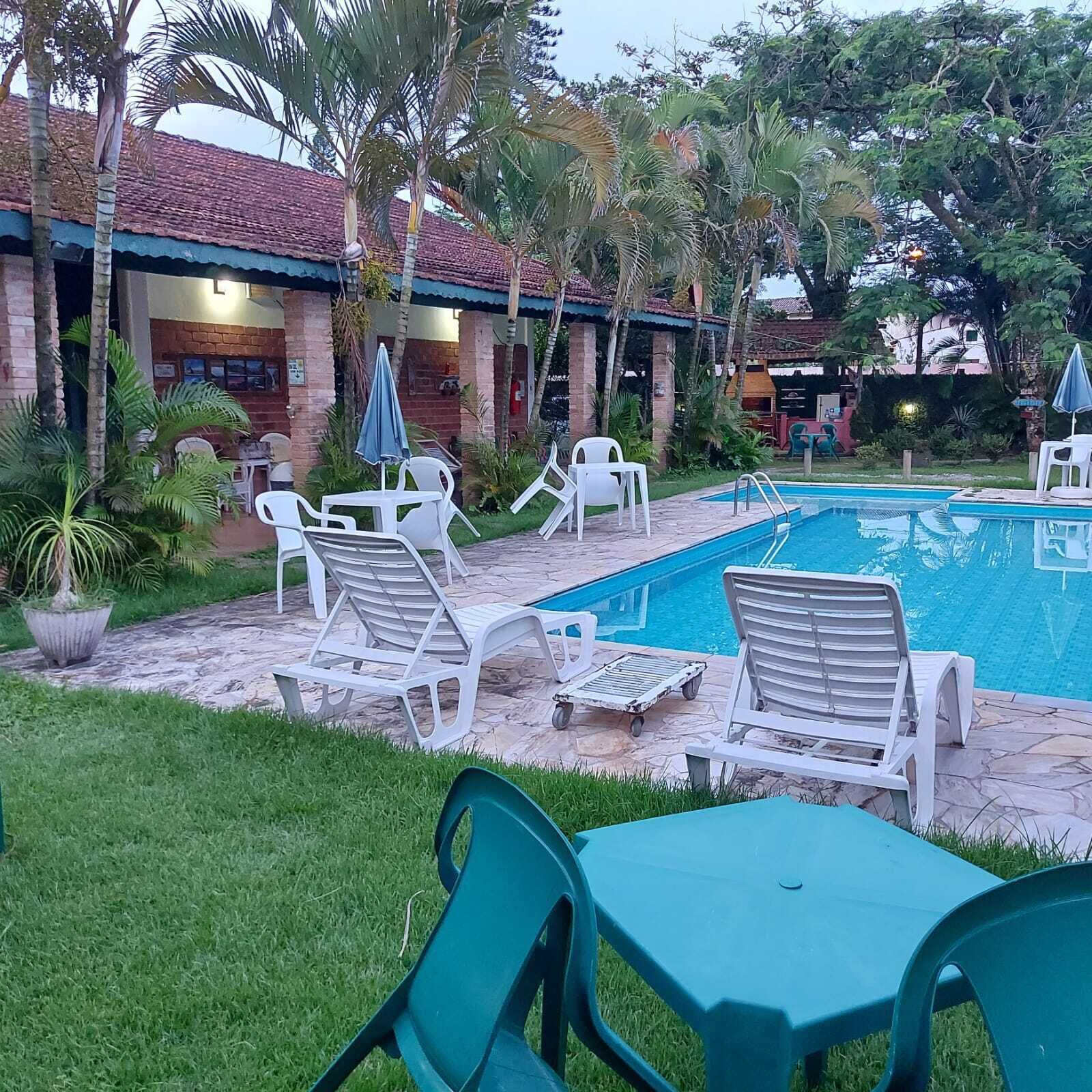 A poolside area with lounge chairs and a swimming pool.