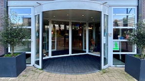 The entrance of the Blue Tower hotel with glass doors and a modern design. - XO Hotels Blue Tower (Amsterdam)