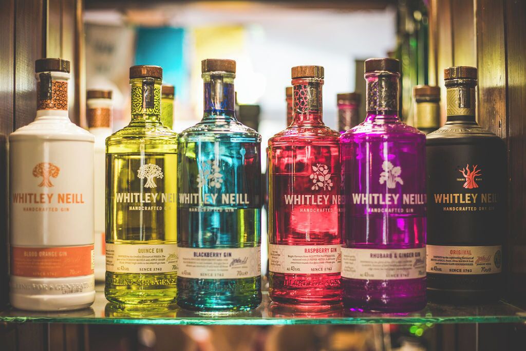 A collection of Whitley Neill gin bottles on a shelf.