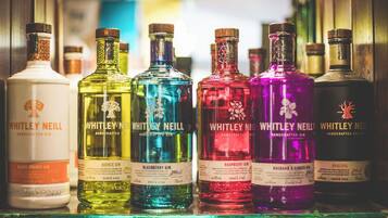 A collection of Whitley Neill gin bottles on a shelf.