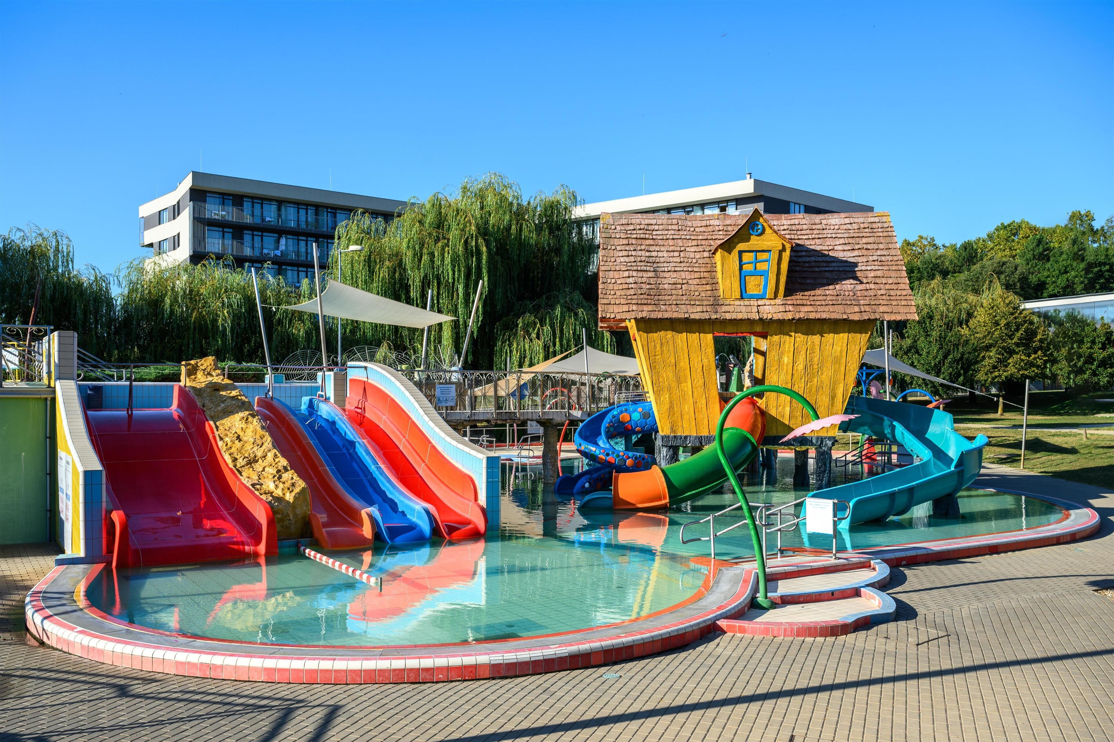 A water park with multiple slides and a pool area.