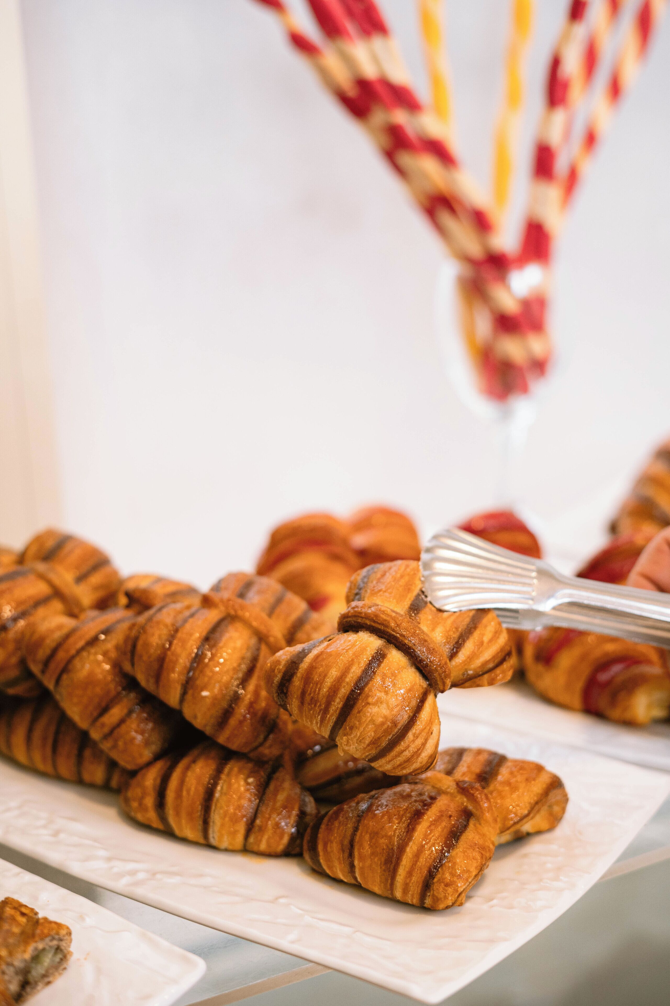A tray of croissants with a fork.